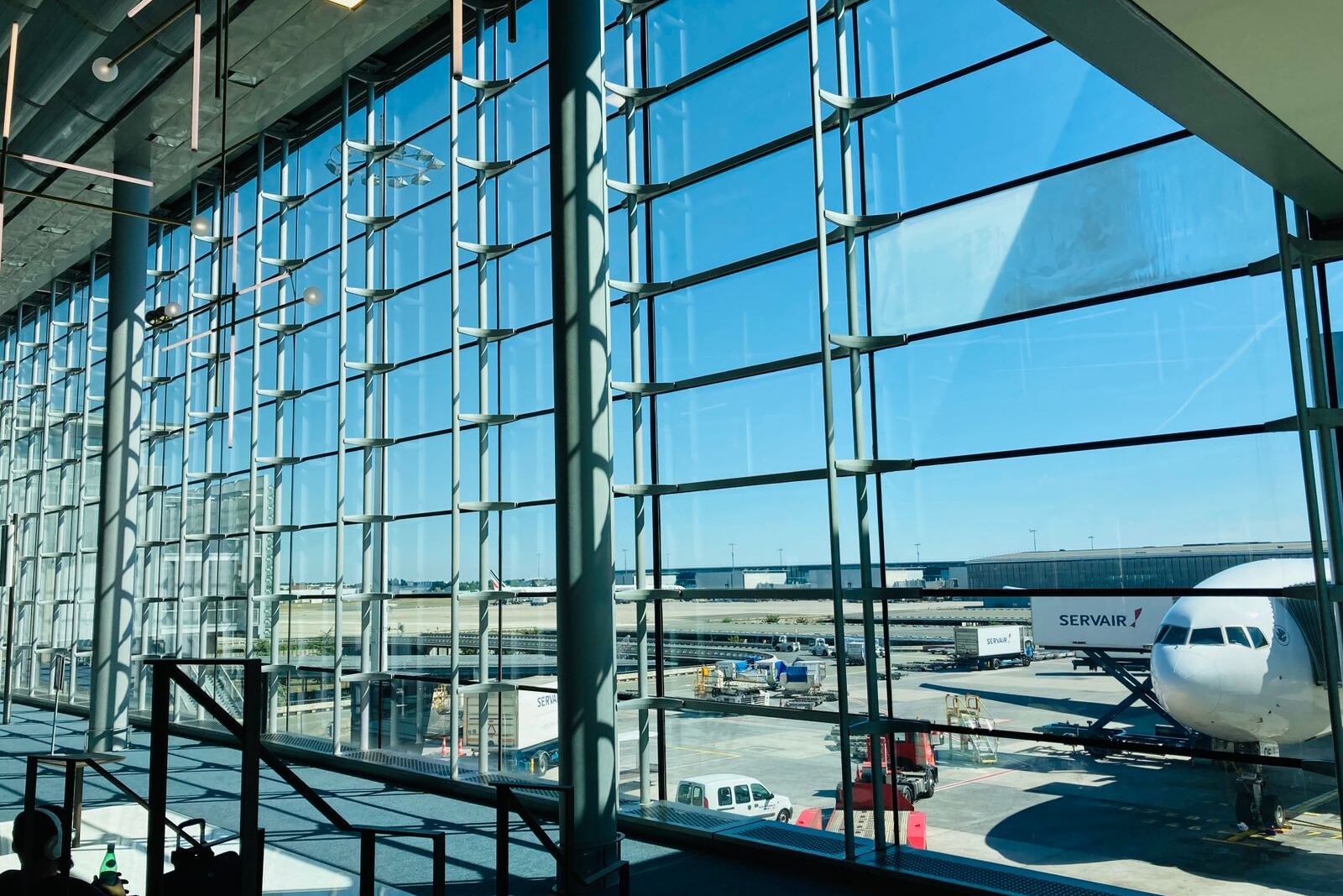 Airport terminal glass wall with an aircraft at the gate