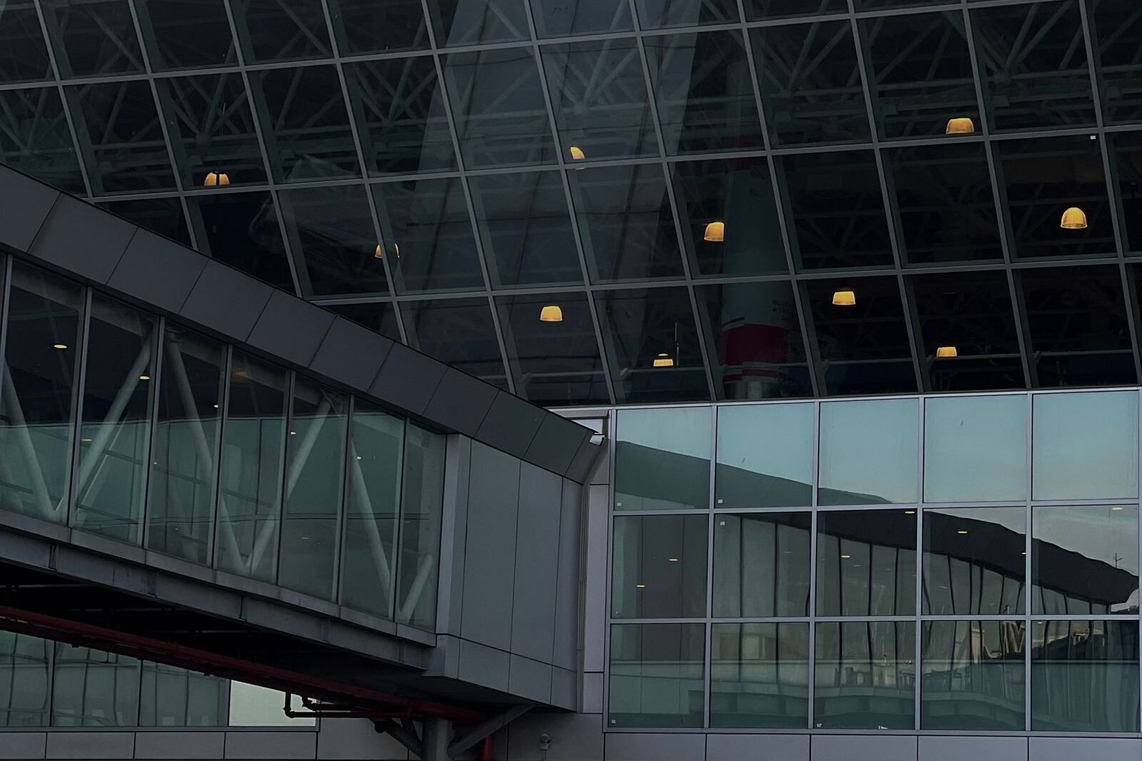 Glass facade and jet bridge of an airport terminal